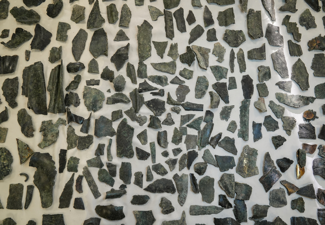 An organized presentation of hundreds of bronze statue fragments from the excavation, reflecting the scale of the discovery and the evidence of recycling practices in the late antiquity period.